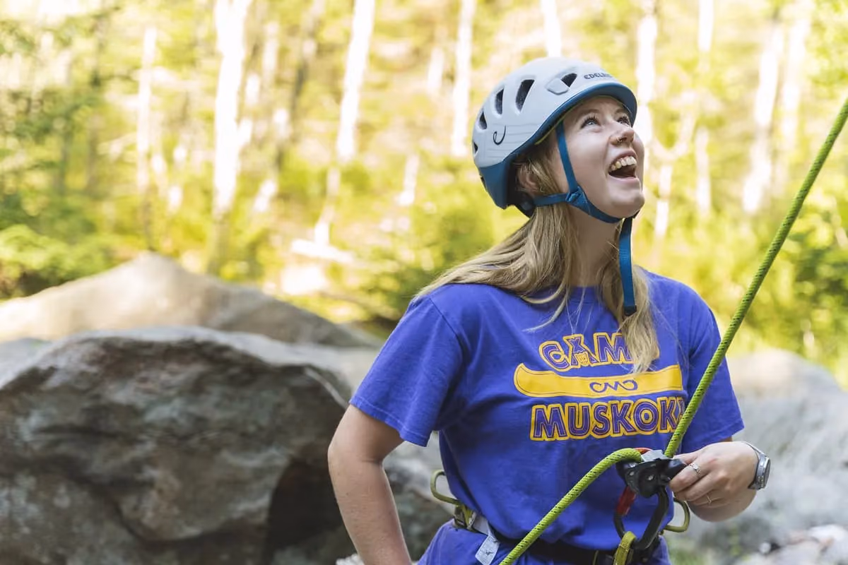 A rock climbing instructor setting up for a climb