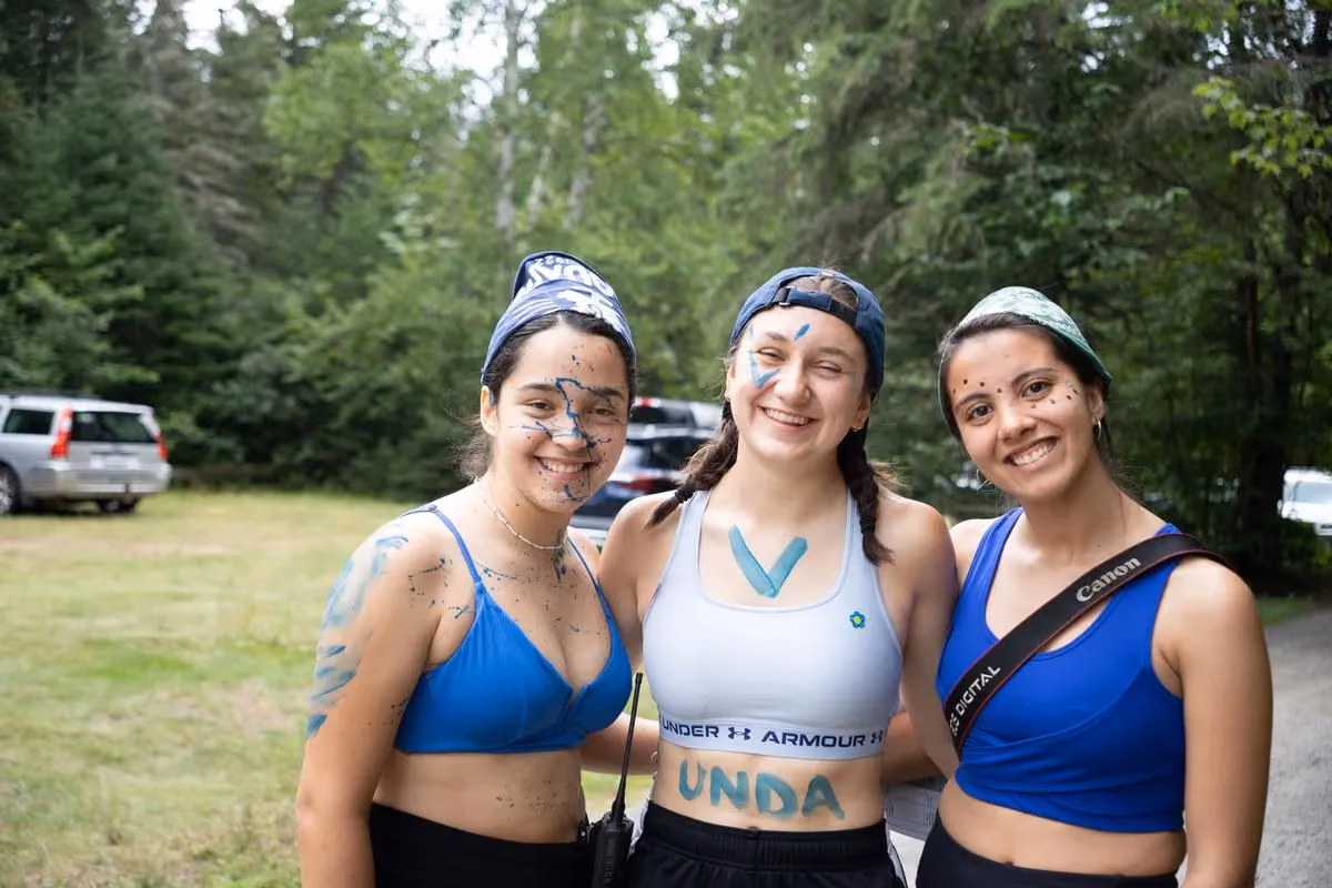 Three camp counselors wearing body paints 