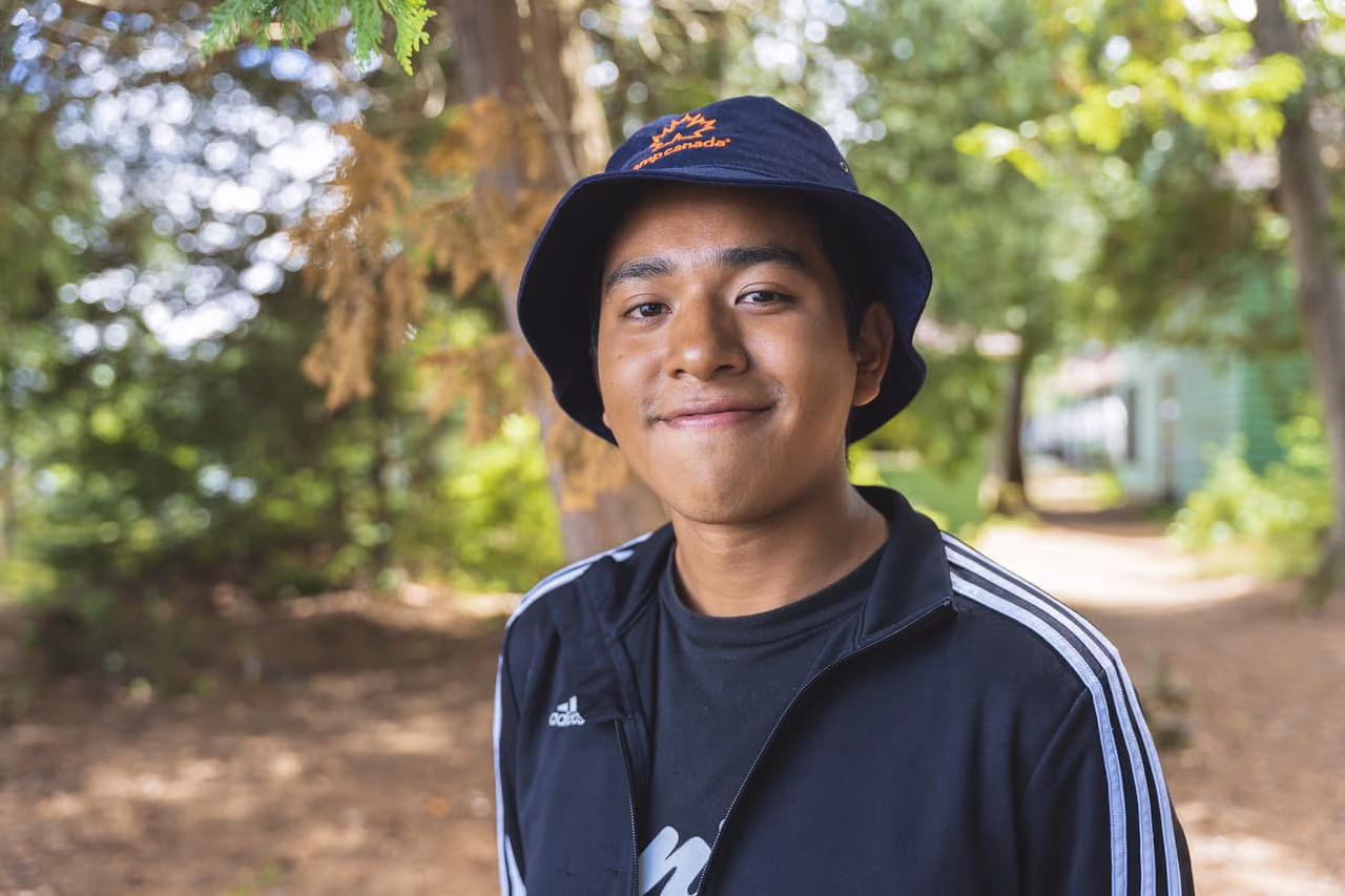 A camp counselor wearing a Camp Canada branded bucket bucket hat